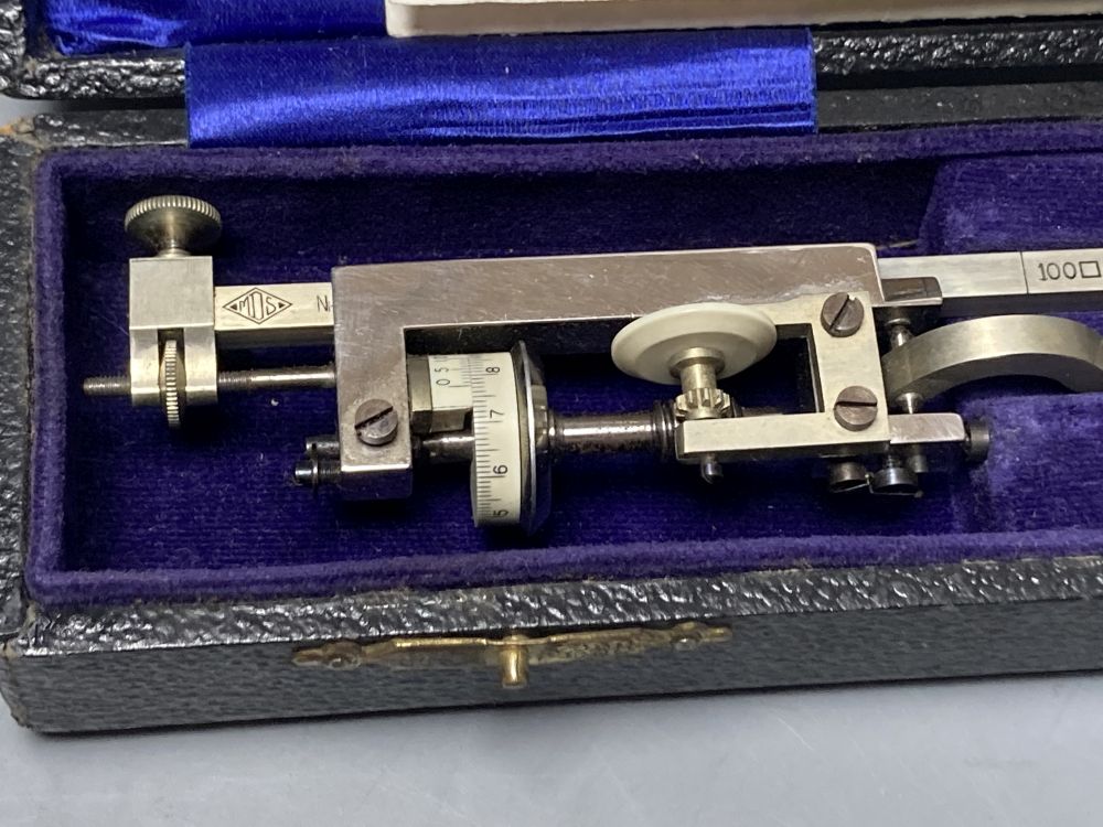 A vintage polished steel planimeter by M.D.S, cased with illustrations